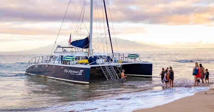 Kai Kanani catamaran pulled up on the sand at Maluaka Beach at sunrise