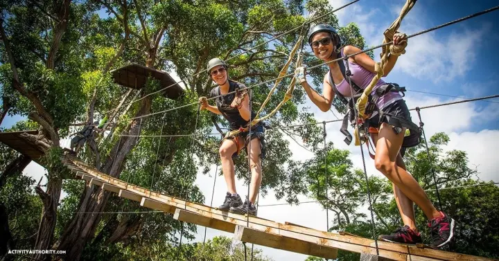 Zipliners crossing a treetop suspension bridge on Maui's North Shore